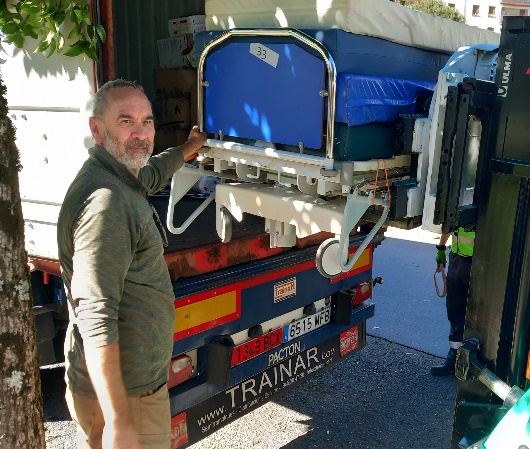 A hospital bed being loaded onto a truck